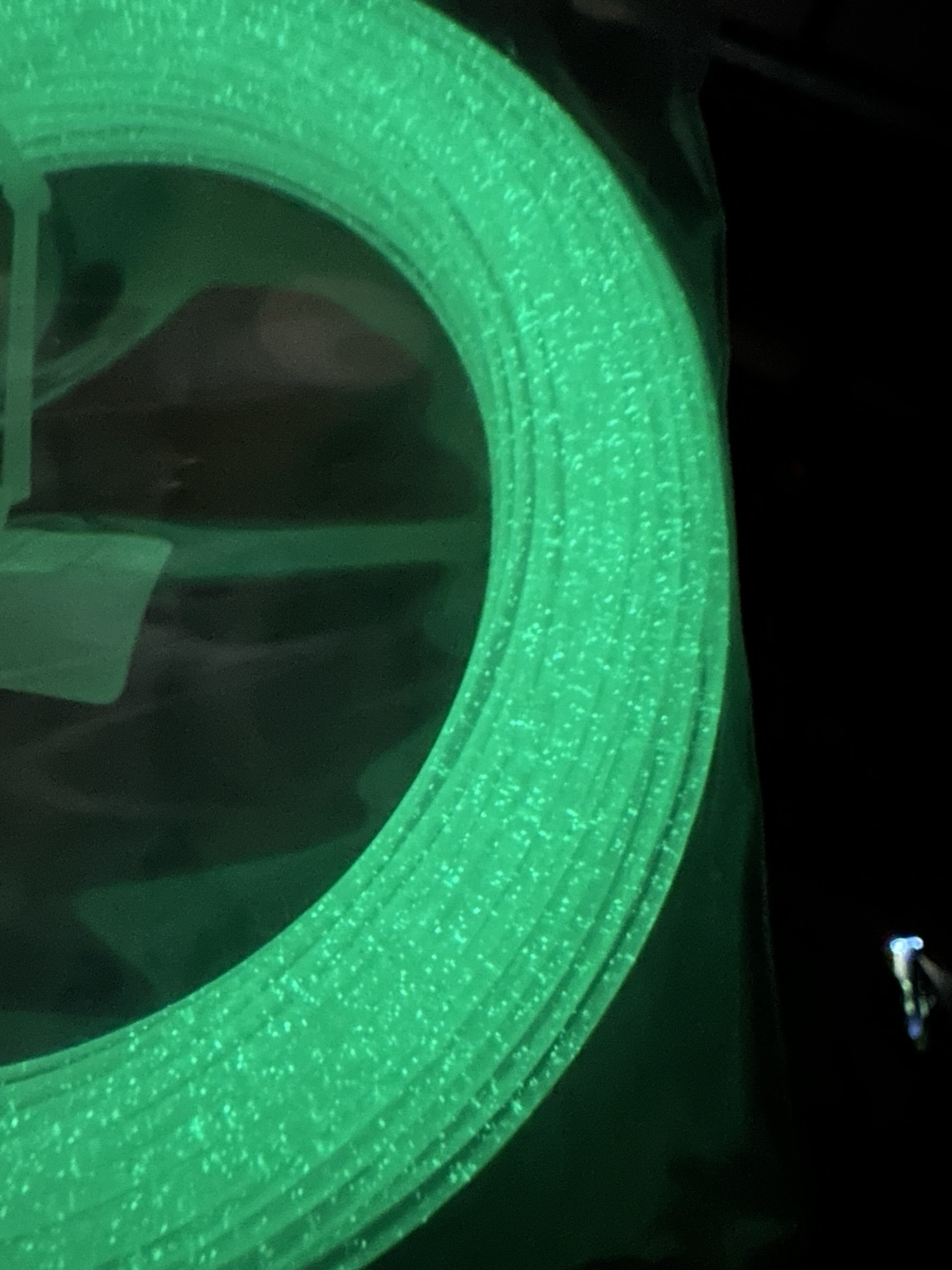 Closeup of green glow in the dark filament sample. It's green and sparkly.